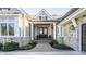 Inviting front porch with double doors, stone accents, and manicured landscaping at 340 Beechwood Farm Ln, Indianapolis, IN 46260