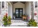 Charming entryway featuring stone pillars, elegant black double doors, and a cozy outdoor seating area at 340 Beechwood Farm Ln, Indianapolis, IN 46260