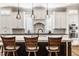Beautiful kitchen with a large center island, pendant lighting, and custom white cabinetry at 340 Beechwood Farm Ln, Indianapolis, IN 46260