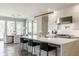 Open kitchen featuring a large island with seating, modern lighting, and a seamless transition to the dining area at 340 Beechwood Farm Ln, Indianapolis, IN 46260