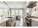 Spacious kitchen with stainless steel appliances, modern cabinetry, and an island sink overlooking the dining area at 340 Beechwood Farm Ln, Indianapolis, IN 46260
