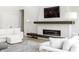 Living room with a modern fireplace featuring a white textured surround and dark wood mantle at 340 Beechwood Farm Ln, Indianapolis, IN 46260