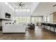 Open-concept living room with fireplace, large windows, seamless flow to kitchen and dining areas at 340 Beechwood Farm Ln, Indianapolis, IN 46260