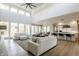 Open-concept living room with high ceilings, large windows, and seamless flow to kitchen area at 340 Beechwood Farm Ln, Indianapolis, IN 46260