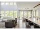 Open-concept living room seamlessly connecting to the kitchen and dining areas, filled with natural light at 340 Beechwood Farm Ln, Indianapolis, IN 46260
