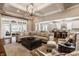 Open-concept living room with coffered ceilings, hardwood floors, and views into kitchen at 340 Beechwood Farm Ln, Indianapolis, IN 46260