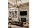 Elegant living room with stone fireplace, custom built-ins and decorative chandelier at 340 Beechwood Farm Ln, Indianapolis, IN 46260