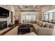 Cozy living room featuring a stone fireplace, plush seating, and natural light at 340 Beechwood Farm Ln, Indianapolis, IN 46260