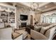 Inviting living room with stone fireplace, built-in shelving, and open layout at 340 Beechwood Farm Ln, Indianapolis, IN 46260