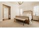 Spacious bedroom with a king bed, bench, side tables, and ensuite access at 340 Beechwood Farm Ln, Indianapolis, IN 46260