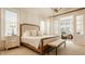 Bright bedroom with a large bed, bench, side table, and elegant decor at 340 Beechwood Farm Ln, Indianapolis, IN 46260