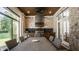 An outdoor kitchen with stainless steel appliances and stone walls under a wood ceiling at 340 Beechwood Farm Ln, Indianapolis, IN 46260