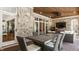 An outdoor living area featuring a stone wall, comfortable seating, and an outdoor kitchen at 340 Beechwood Farm Ln, Indianapolis, IN 46260
