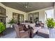 Covered outdoor living space complete with plush seating, ceiling fan, and decorative accents at 340 Beechwood Farm Ln, Indianapolis, IN 46260