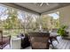 Relaxing covered patio showcasing wicker furniture and views of a lush lawn at 340 Beechwood Farm Ln, Indianapolis, IN 46260