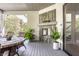 Inviting covered patio features an outdoor fireplace and views of the landscaped yard at 340 Beechwood Farm Ln, Indianapolis, IN 46260