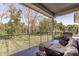 Covered patio with comfortable seating, perfect for enjoying the serene wooded view at 340 Beechwood Farm Ln, Indianapolis, IN 46260