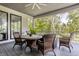 Covered patio featuring wicker furniture, a ceiling fan, and peaceful outdoor views at 340 Beechwood Farm Ln, Indianapolis, IN 46260
