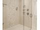 Modern shower with light tile, glass door, and built in shelving at 340 Beechwood Farm Ln, Indianapolis, IN 46260
