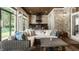 Cozy sunroom featuring stone walls, a view to the backyard, and comfortable wicker furniture at 340 Beechwood Farm Ln, Indianapolis, IN 46260