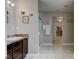 Hallway view of a tiled bathroom with a vanity, sink, and a walk-in closet in the background at 11851 Fawn Crest Dr, Indianapolis, IN 46235