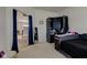 Bedroom showcasing an open wardrobe and view to living area at 11851 Fawn Crest Dr, Indianapolis, IN 46235