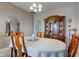 Formal dining room with a chandelier, large table, hutch, and a view of the mirror at 11851 Fawn Crest Dr, Indianapolis, IN 46235