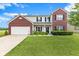 Beautiful two-story home featuring brick and vinyl siding with manicured front yard at 11851 Fawn Crest Dr, Indianapolis, IN 46235