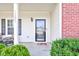 A close-up of the front door, house number, and chairs on the home's front porch at 11851 Fawn Crest Dr, Indianapolis, IN 46235