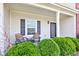 Charming front porch with seating, decorative shrubs, and a view of the house number at 11851 Fawn Crest Dr, Indianapolis, IN 46235
