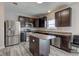 Well-equipped kitchen with stainless steel appliances, dark cabinets, island and lots of counter space at 11851 Fawn Crest Dr, Indianapolis, IN 46235