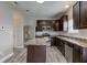 Fully equipped kitchen featuring stainless steel appliances, dark cabinets, and a center island at 11851 Fawn Crest Dr, Indianapolis, IN 46235