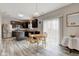 Modern kitchen with stainless steel appliances, dark wood cabinets, a center island, and adjacent dining area at 11851 Fawn Crest Dr, Indianapolis, IN 46235