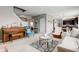 Open concept living room with neutral carpet, a piano, and views to the kitchen and dining area at 11851 Fawn Crest Dr, Indianapolis, IN 46235