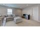 Comfortable living room with a gray sectional sofa and ottoman at 11851 Fawn Crest Dr, Indianapolis, IN 46235