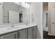 Bathroom with double sink vanity, quartz countertop, gray cabinets, and framed mirror at 16311 Taconite Dr, Noblesville, IN 46060