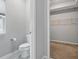 Bright bathroom featuring white toilet and tile floor with a walk-in closet adjacent at 16311 Taconite Dr, Noblesville, IN 46060