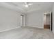 Spacious bedroom with neutral walls, plush carpet, and modern ceiling fan at 16311 Taconite Dr, Noblesville, IN 46060