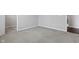 Empty bedroom, featuring gray walls and plush carpet with a view into an adjacent space at 16311 Taconite Dr, Noblesville, IN 46060