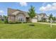 Charming home with brick and siding exterior, manicured lawn, and attached garage at 16311 Taconite Dr, Noblesville, IN 46060