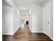 Inviting hallway featuring modern wood floors leading into an open living area with fireplace at 16311 Taconite Dr, Noblesville, IN 46060