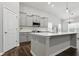 Modern kitchen features gray cabinets, center island and stainless appliances at 16311 Taconite Dr, Noblesville, IN 46060