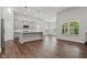 Open kitchen with gray cabinets, center island, stainless appliances and wood floors at 16311 Taconite Dr, Noblesville, IN 46060