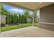 Covered patio overlooking a professionally landscaped backyard with mature trees at 16311 Taconite Dr, Noblesville, IN 46060