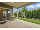 Covered patio overlooking green yard and lush landscaping at 16311 Taconite Dr, Noblesville, IN 46060