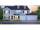 Charming two-story home with symmetrical facade, black shutters, dormer windows, and a manicured front lawn at 6902 Enclave Dr, McCordsville, IN 46055