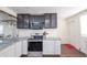 Well-equipped kitchen featuring granite countertops and modern appliances, with dark wood flooring at 3607 Fletcher Ave, Indianapolis, IN 46203