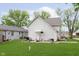 View of home's backyard, green lawn, trees, patio, and exterior at 47 Meadow Dr, New Palestine, IN 46163