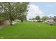 Large backyard view with green lawn, a bench and storage shed at 47 Meadow Dr, New Palestine, IN 46163
