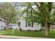 Gray two-story home featuring black shutters, an American flag, and a well-maintained lawn at 47 Meadow Dr, New Palestine, IN 46163